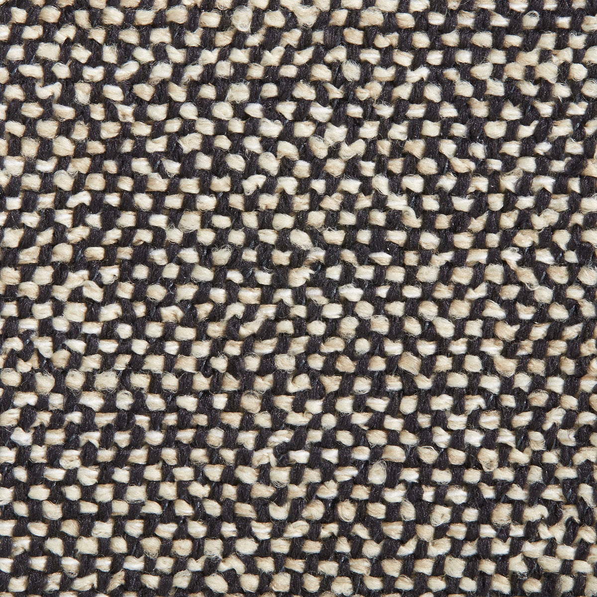 Close-up view of a textured fabric sample in black and beige colors.
