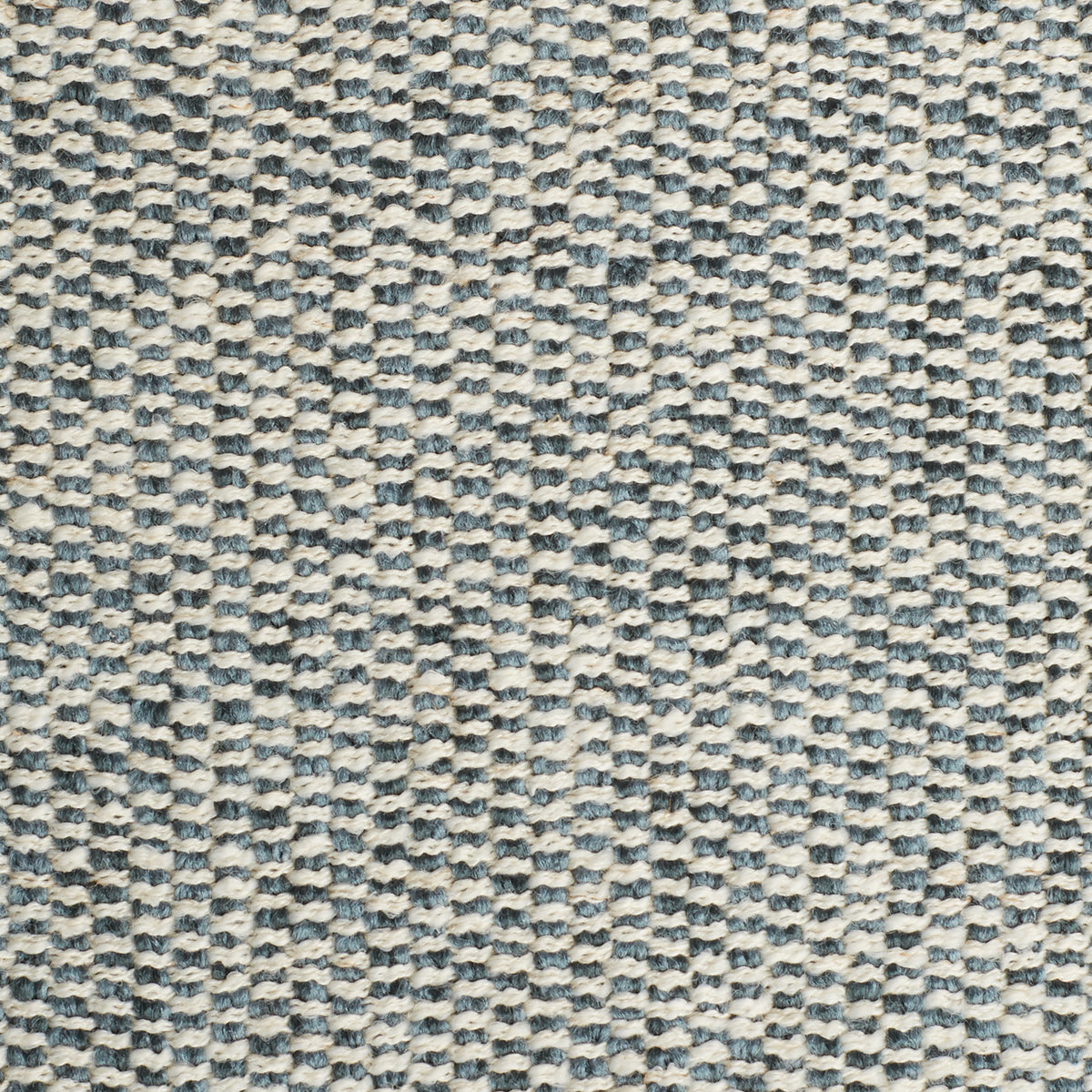Close-up view of a textured fabric with a blue and white pattern.