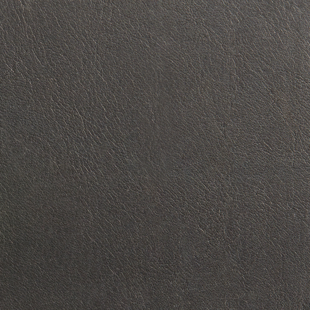 A close-up image of a brown leather material with a textured surface.