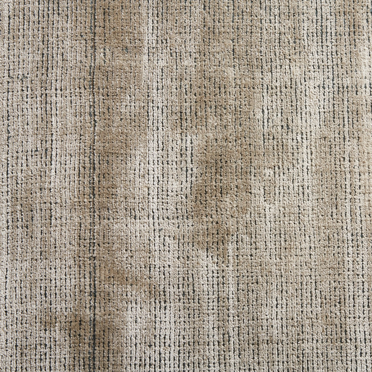 Textured beige fabric with a stain