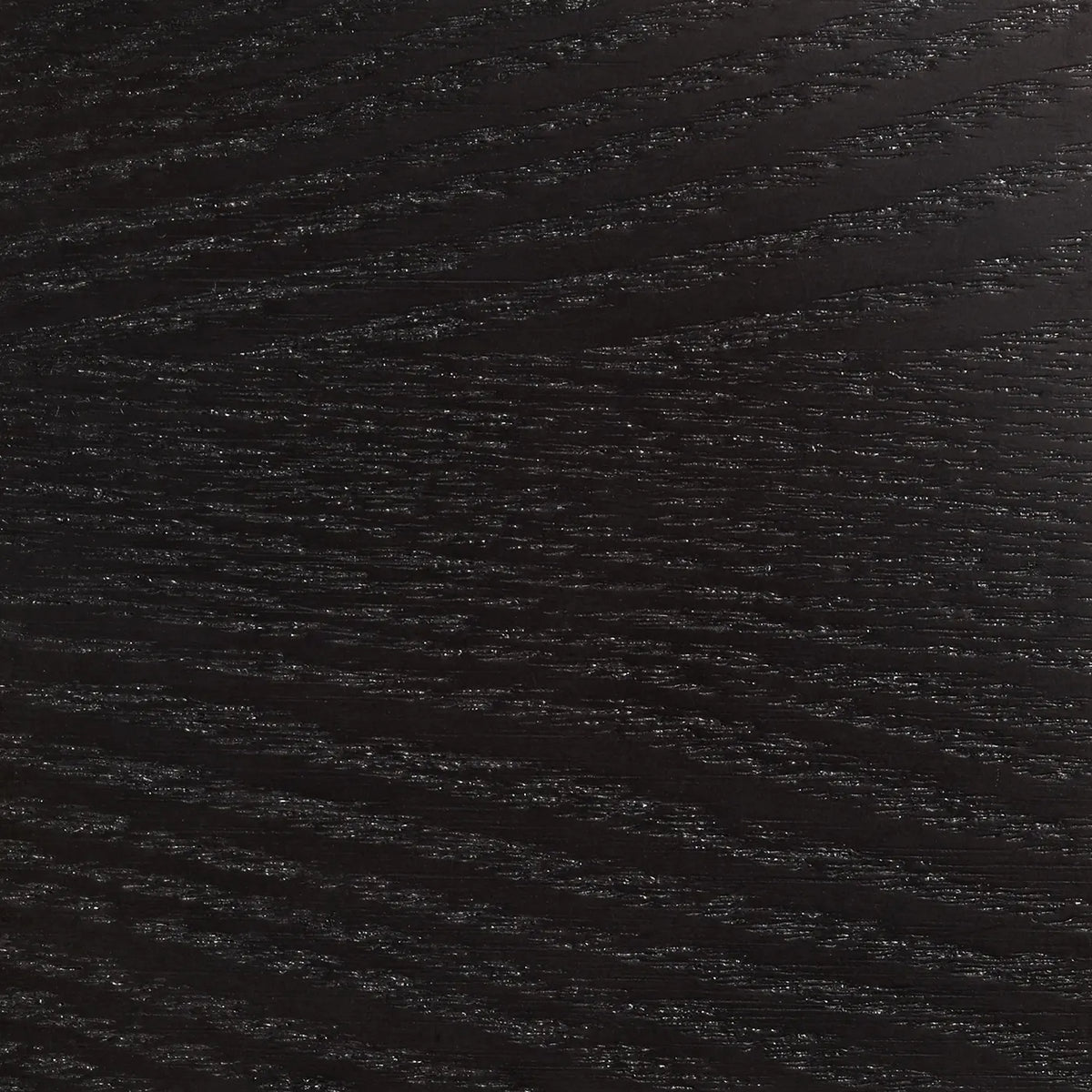 A close-up image of a black textured surface with a grain pattern, possibly a wood grain.